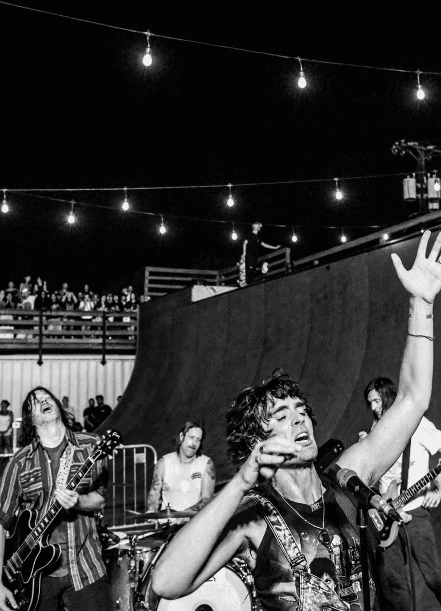 The crowd at a past Pulse of the People night at 4DWN Skatepark, lit by string lights